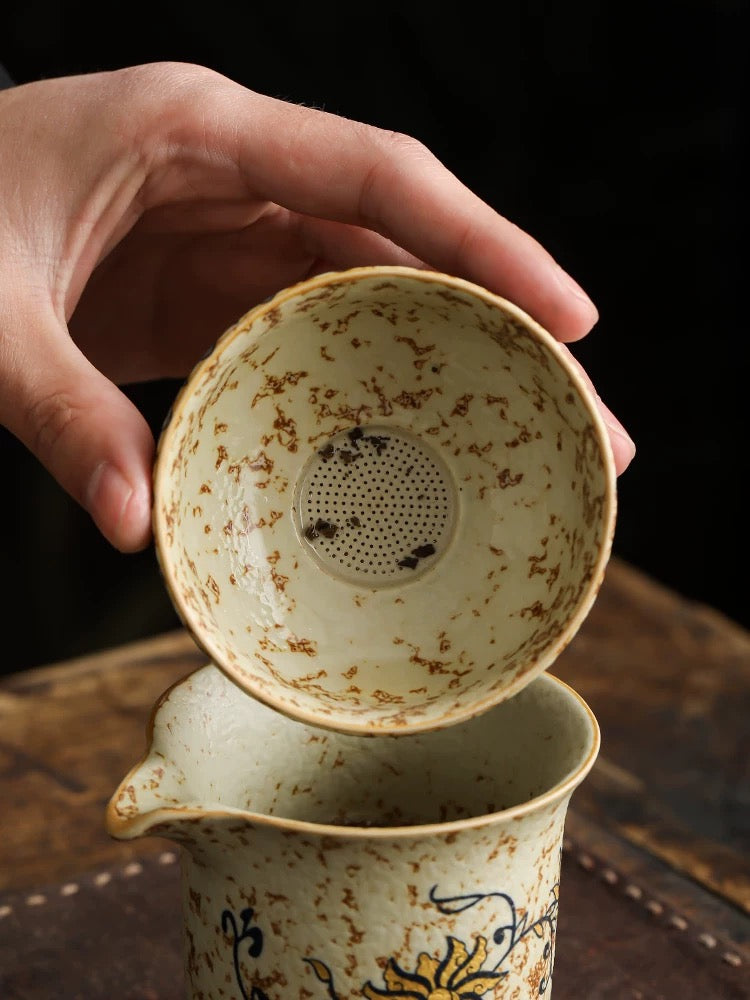 Teacup and tea strainer set